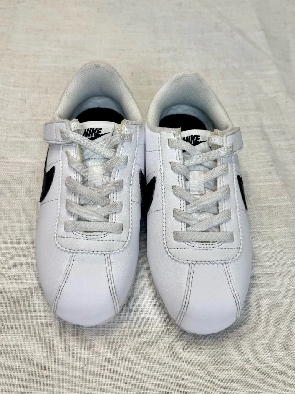 Nike Kids White Sneakers with Black Swoosh
